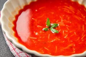 Tomato soup vermicelli gazpacho first course dish fresh gourmet food background on the table rustic food top view copy space photo