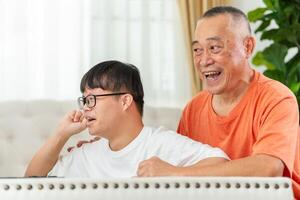 Senior man with grandchild relaxing together at home, Asian family play game in living room photo