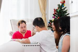 A group of friends playing a game of checkers in living room at home photo