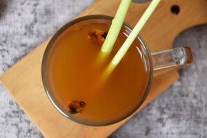 Top view photo of a healthy hot red ginger drink with a mixture of lemon
