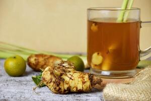 Healthy hot red ginger drink with a mixture of lemon and honey photo