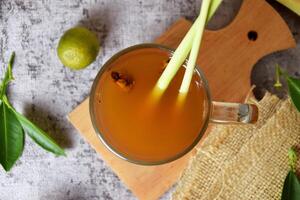 Top view photo of a healthy hot red ginger drink with a mixture of lemon