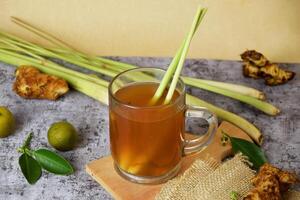 Closeup photo of a healthy hot drink of ginger with lemon and honey