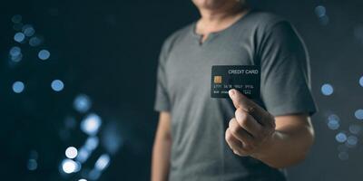 businessman showing a mock-up credit card for business and shopping to make payment and smartphone.half body. purchase, commerce, financial, card, money, using technology. selective focus. photo