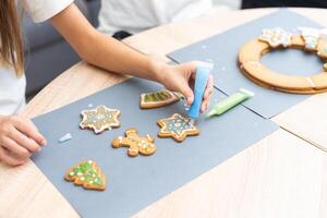 Child preparing Christmas cookies at table, top view photo
