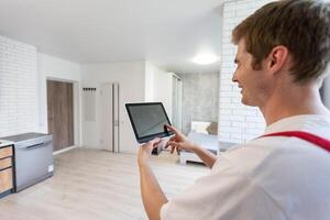 man holding tablet with app smart home on screen photo