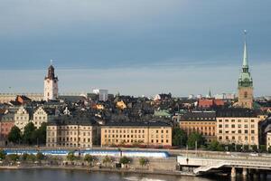 Stockholm skyline. Train crossing the bridge connecting islands photo