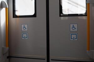 Equipped exit for disabled people in public transport with sticker signs, comfortable ramp for people with disabilities, ramp sign for convenient exit for wheelchair users photo