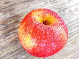 A red apple with water droplets on it photo