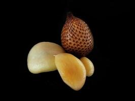 A group of three nuts on a black background photo