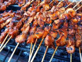 A grill with skewers of meat on it photo