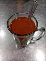 A glass cup with a spoon in it photo