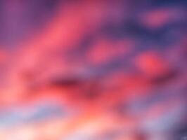 A blurry image of a sunset with clouds photo