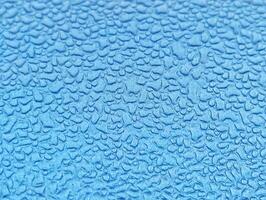 Water drops on a blue surface photo