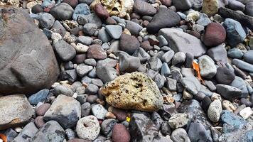 A pile of rocks and pebbles on the beach photo