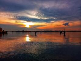 A boat is in the water at sunset photo