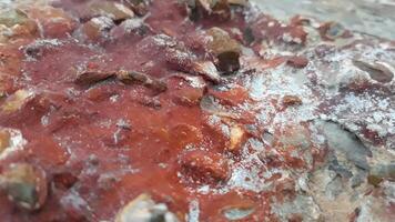 A close up of a rock with red and white paint photo