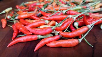 A pile of red and orange chili peppers photo