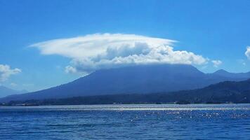 A large cloud over a mountain photo