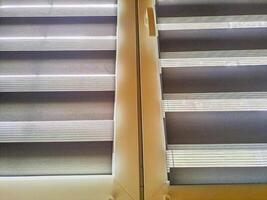 Window roller, duo system day and night. Dual roller shades beige color close-up photo