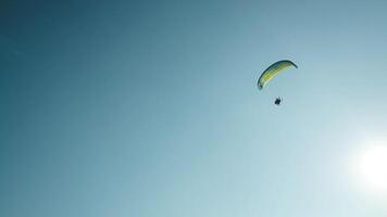 Alone paraglider flying in the blue sky against the background. Paragliding into a beautiful sky alone video