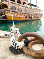 Close-up of mooring cable node of ship, holding moored vessel, symbol of reliability, vertical frame. photo