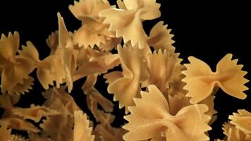 Farfale pasta flies in and falls. Filmed on a high-speed camera at 1000 fps. High quality FullHD footage video