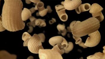 Dry pasta flies down. Filmed on a high-speed camera at 1000 fps. High quality FullHD footage video