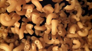 The dry pasta flies up and falls down. Filmed on a high-speed camera at 1000 fps. High quality FullHD footage video