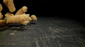 Dry pasta falls on the table. Filmed on a high-speed camera at 1000 fps. High quality FullHD footage video