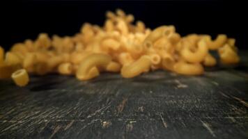 Dry pasta falls on the table. Filmed on a high-speed camera at 1000 fps. High quality FullHD footage video