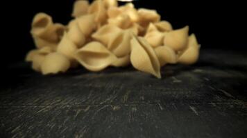 Dry pasta falls on the table. Filmed on a high-speed camera at 1000 fps. High quality FullHD footage video