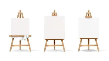 Three easels with blank canvas on them photo
