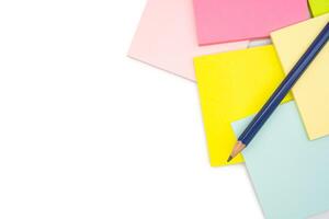 Pencil on blank colorful sticky note isolated on white background. Copy space. photo