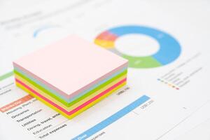 Stack empty sticky note paper sheet on graph background. colorful sticky note papers. photo