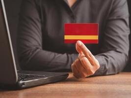 Close-up of hand a businessman in a black shirt holding a name card mockup while sitting in the office photo