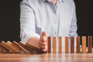 Stopping the domino business crisis effect before the business collapse photo