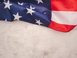Top view of the American flag on a cement floor with copy space for text. photo