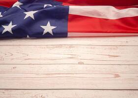 Top view of the American flag on a wooden tabler with copy space for text. photo
