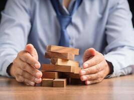 Hands businessman protect business crisis effect before the business collapse photo