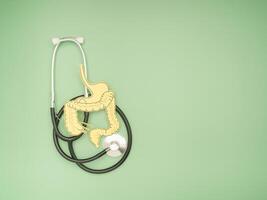 A large intestine shape made from paper and a stethoscope on a green background photo