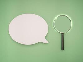 Top view of a blank speech bubble and a magnifying glass on a green background photo