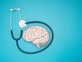 A brain shape made from paper and a stethoscope on a blue background photo