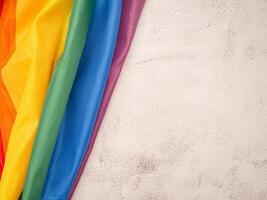 Top view of the rainbow flag or LGBT is on a cement floor with copy space photo
