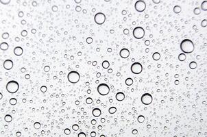 Close-up of water droplets scattered on a smooth surface. Hydration concept. photo