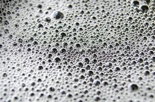 Top view of tiny bubbles on dark background. Suitable for wallpaper or design photo