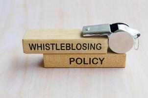 Whistleblowkng Policy text on wooden blocks. Whistleblowing concept photo