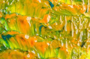 Top view of yellow paining with other multicolored painting background photo