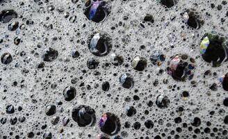 Macro view of bubbles forming on the water surface photo