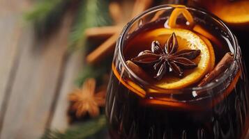 A glass of mulled wine with cinnamon and star anise photo